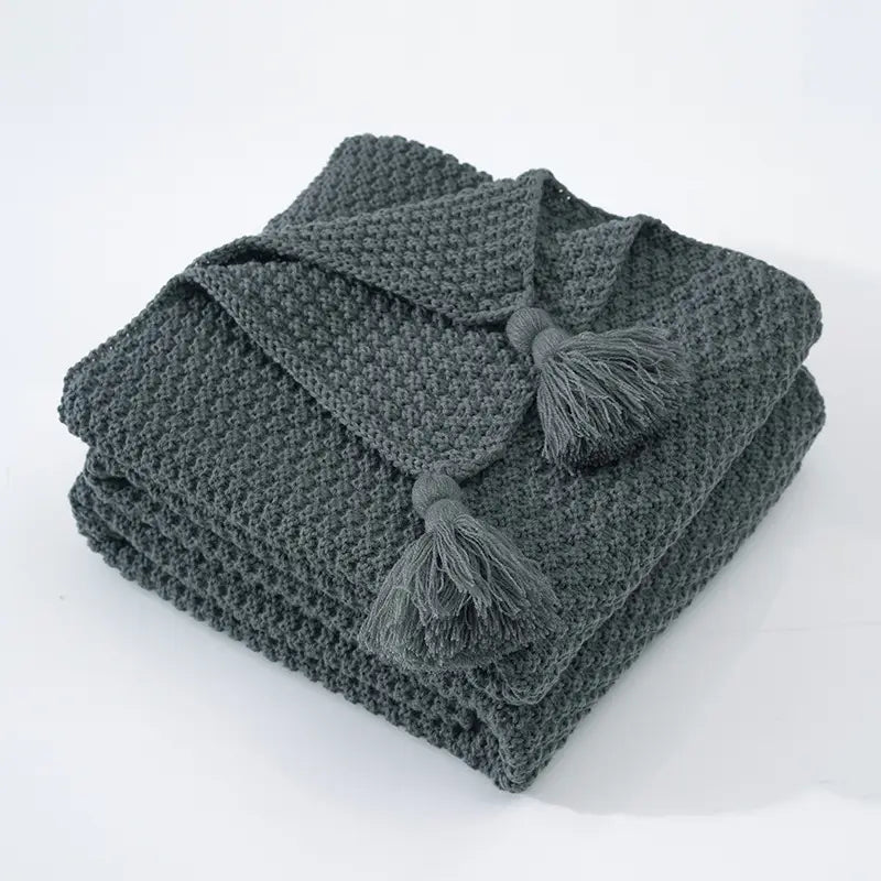 Couverture tricotée à pompons grise
